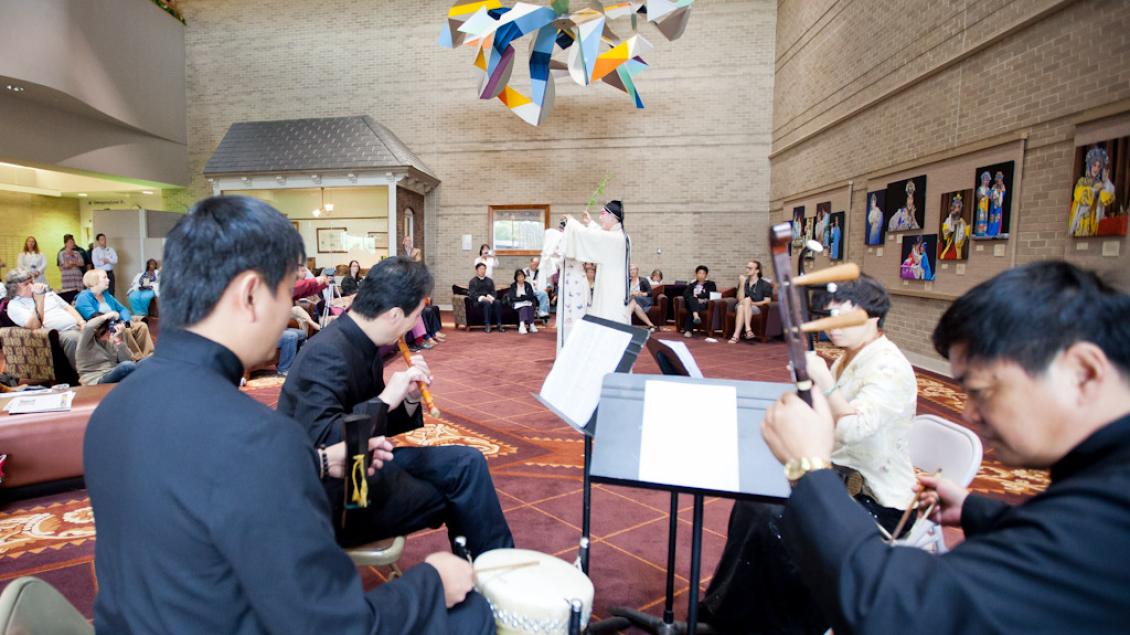 Small group of Chinese musicians playing for patients and staff